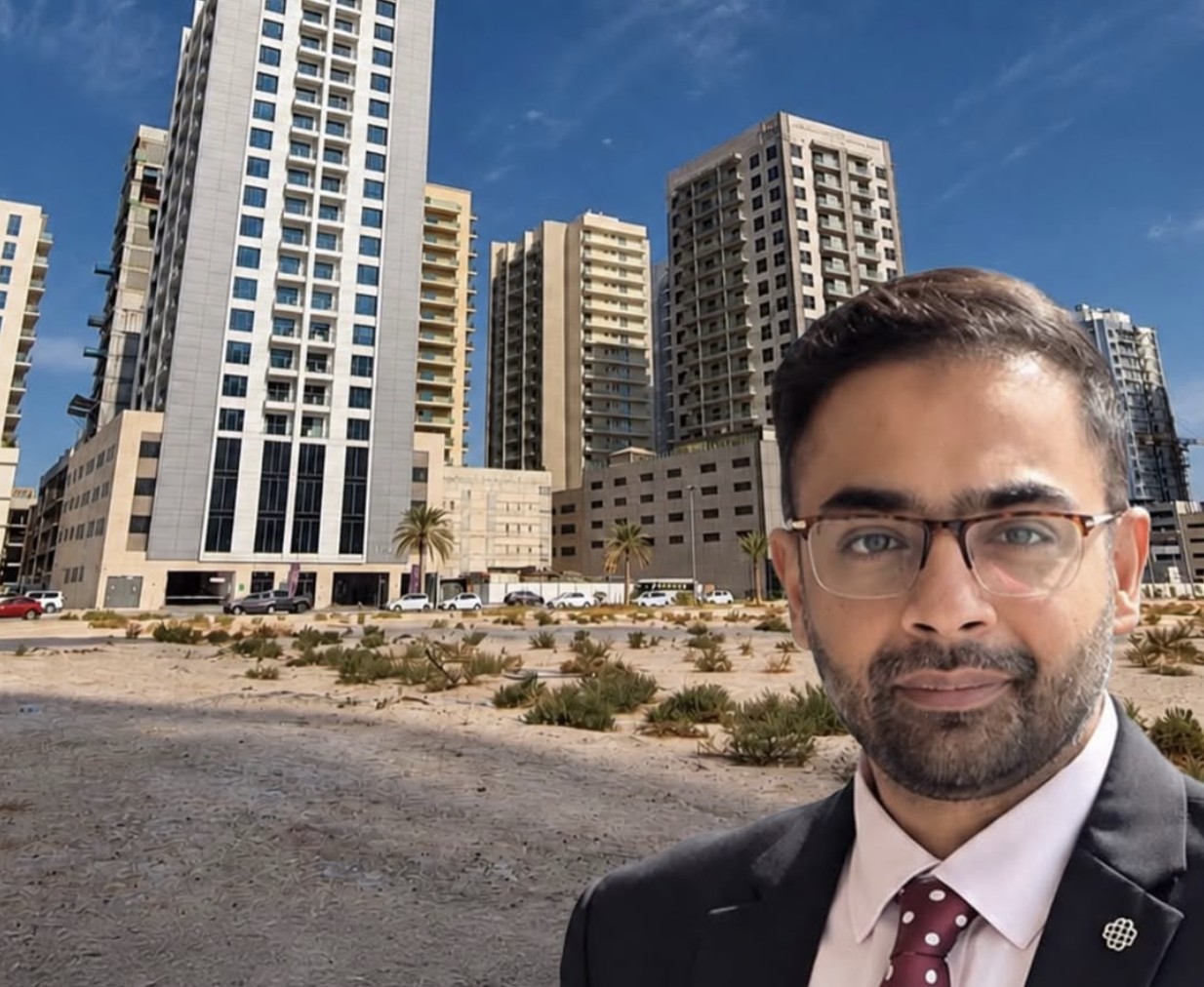 Omair Siddiqi, Founder and CEO of Blueworld Real Estate, standing in front of Dubai towers